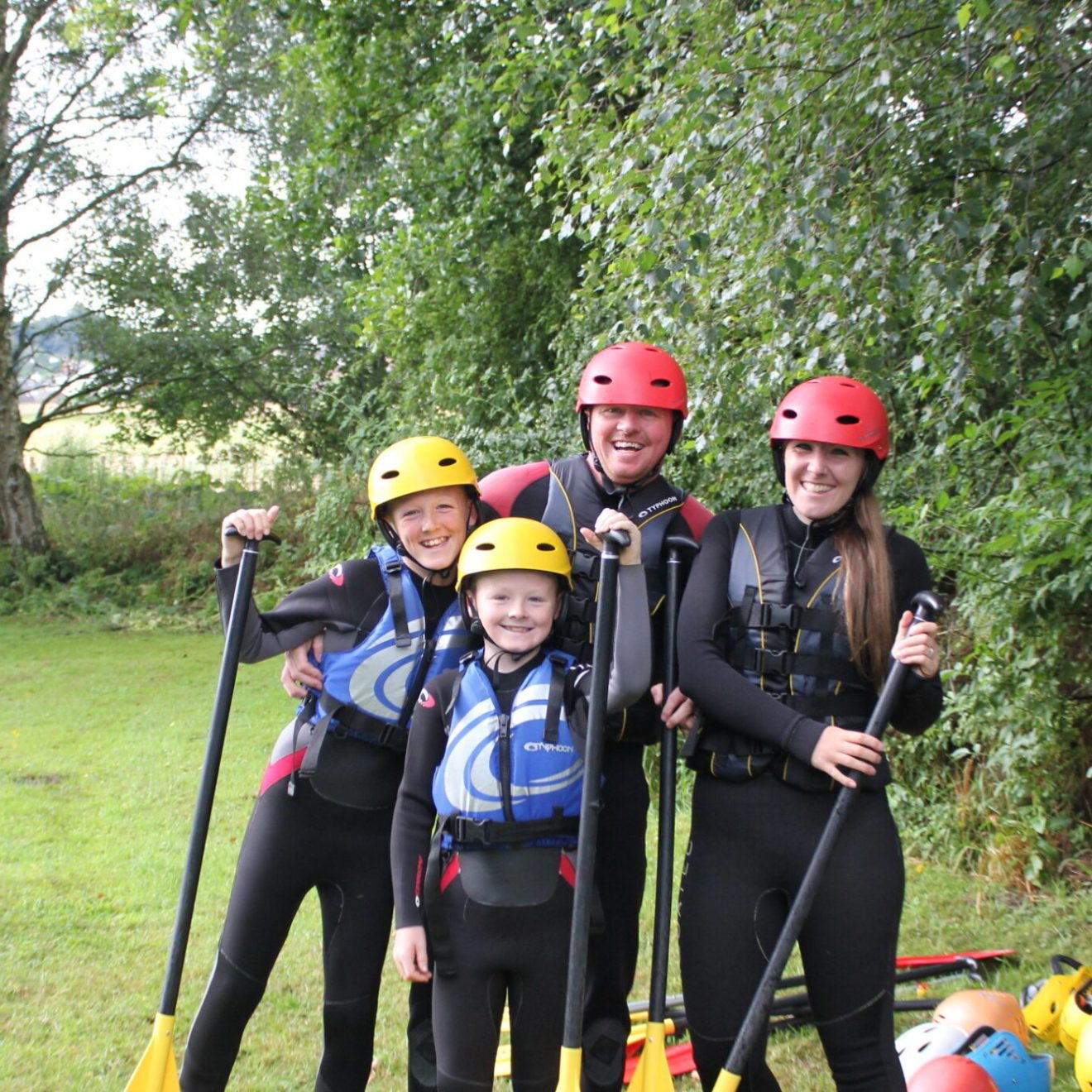 a family posing with paddles