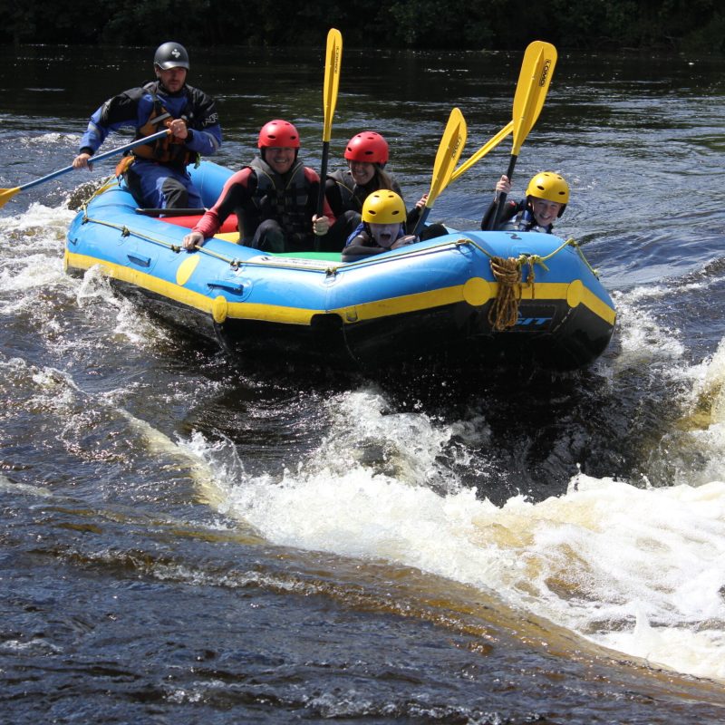 a group of people white water rafting in lake district, cumbria
