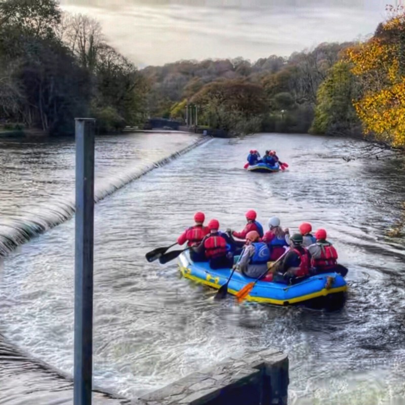a group of people white water rafting in lake district, cumbria