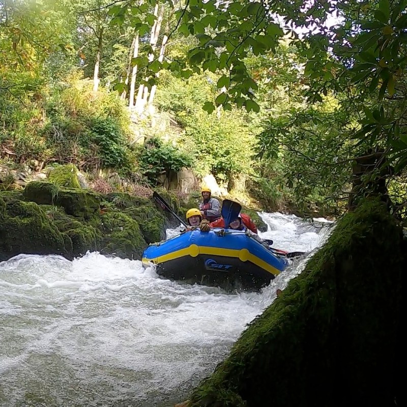 a group of people white water rafting in lake district, cumbria