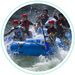 a round image of a group of people white water rafting in lake district, cumbria